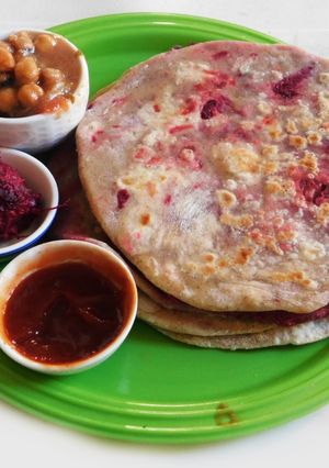 A picture of A lunch to kill for--  Beetroot masala Parantha with chickpea beetroot masala curry.
