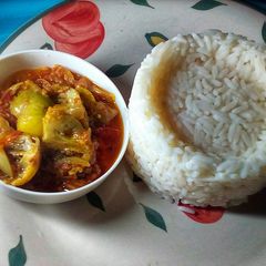 A picture of Scooped Rice and Garden Egg Sauce.