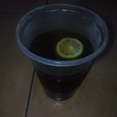 A picture of Black coffee with a lemon.
