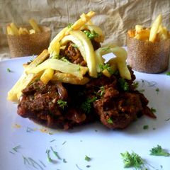 A picture of Mutton Kurma with Crispy french fries.
