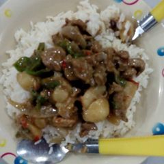 A picture of White rice with beef soup.