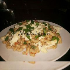 A picture of Jollof macaroni and scrambled eggs.