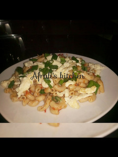 A picture of Jollof macaroni and scrambled eggs.