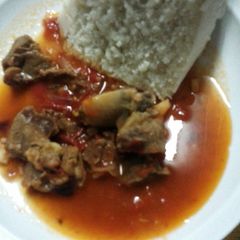A picture of Beef stew and ugali.