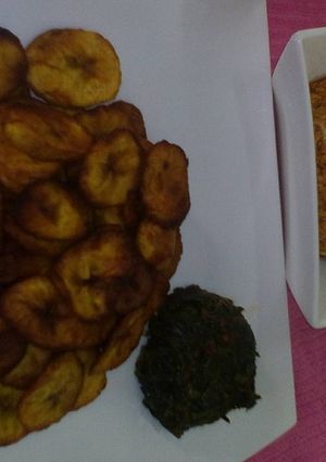 A picture of Fried plantain with egg sauce and vegetable.