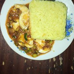 A picture of Tumeric rice and egg curry.