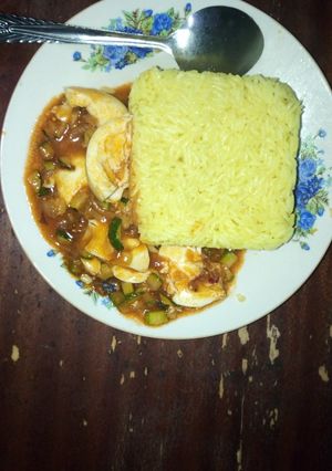 A picture of Tumeric rice and egg curry.