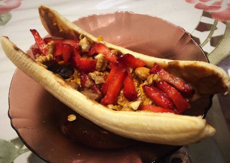 Healthy banana split boat for breakfast. With granola and almond butter