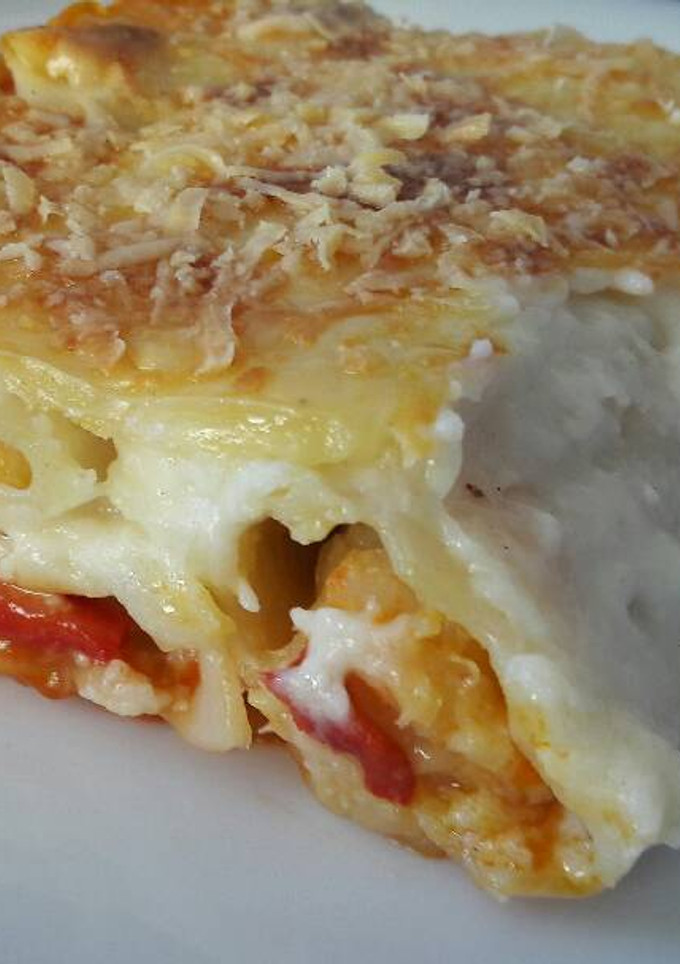 Una foto de Canelones con bacalao y gambas
