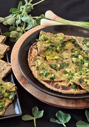 A picture of Stuffed Bajri rotlo with spring onions and methi.