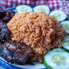 A picture of Cucumber jollof rice and fried fish.
