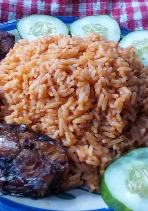 A picture of Cucumber jollof rice and fried fish.