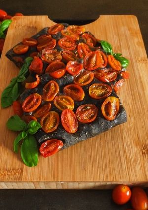 A picture of Charcoal Focaccia with Herbes de Provence, Thyme, and Cherry Tomatoes.