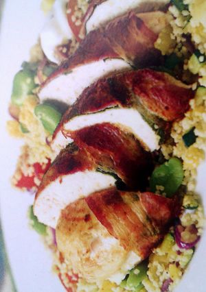 A picture of Pancetta-wrapped chicken with cous cous.