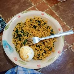 A picture of Indomie, egg and vegetable (ugu).