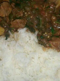 A picture of Beef Stew served with Rice.