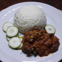 A picture of Chicken in spicy peanut powder sauce with rice.