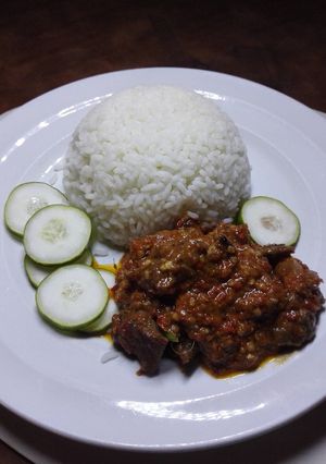 A picture of Chicken in spicy peanut powder sauce with rice.