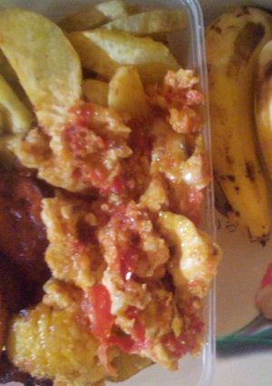 A picture of Fried potatoes/plantain and egg sauce plus banana.