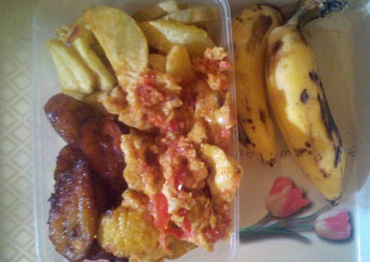 Fried potatoes/plantain and egg sauce plus banana
