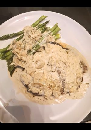 A picture of Rib eye steak in white sauce.