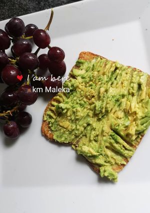 A picture of Mashed 🥑 avocado on bed of toasted bread.