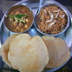 A picture of Chole Puri with sweet vermicelli.