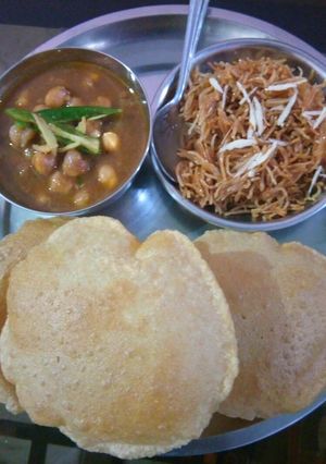 A picture of Chole Puri with sweet vermicelli.