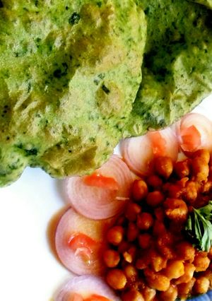 A picture of Chhole with palak bhatura.