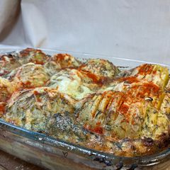 A picture of Baked Potatoes with Cheese in the Oven.