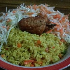 A picture of Fried Rice and Chicken with coleslaw.