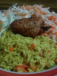 A picture of Fried Rice and Chicken with coleslaw.