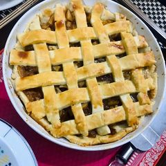 A picture of Apple pie with flaky butter crust served with vanilla ice cream.