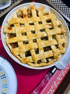 A picture of Apple pie with flaky butter crust served with vanilla ice cream.