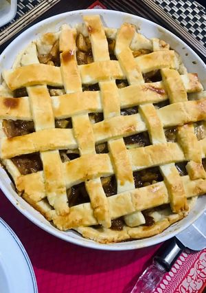 A picture of Apple pie with flaky butter crust served with vanilla ice cream.