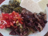 Nyama choma with traditional vegetables and Kachumbari