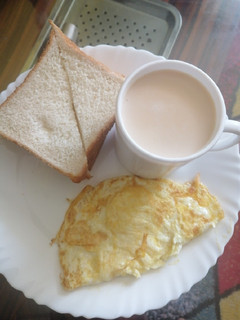 A picture of Cinnamon tea milk, slice of bread and eggs.