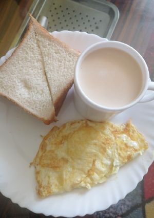 A picture of Cinnamon tea milk, slice of bread and eggs.