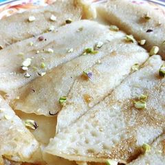 A picture of Patisapta pitha(stuffed pancake roll).