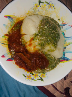 A picture of Semovita with okra soup and stew.