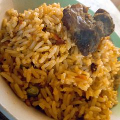 A picture of Jellof rice and fried beef.