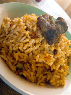 A picture of Jellof rice and fried beef.