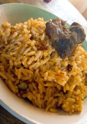 A picture of Jellof rice and fried beef.