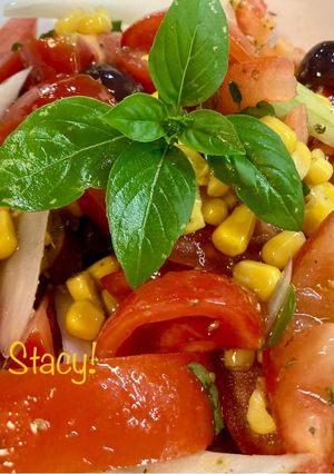 A picture of Tomato Salad with Sweet Corn and Olives.