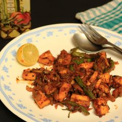 A picture of Squid cubes and beans stir fry in kerala spicy-roast coating.