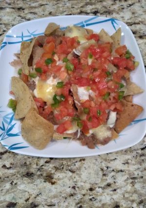 A picture of Nachos with Pico de Gallo.