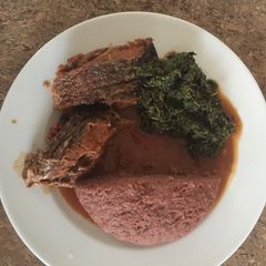 A picture of Tilapia, kienyeji greens and ugali.