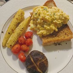 A picture of Breakfast of the day: scrambled eggs over toast.