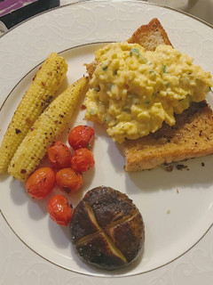 A picture of Breakfast of the day: scrambled eggs over toast.
