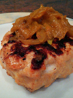 A picture of Goat cheese chicken burger with curried onions. .